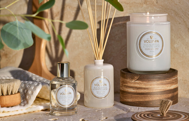 Voluspa Eucalyptus & White Sage room spray styled with a reed diffuser and candle, part of the Voluspa luxury room spray collection