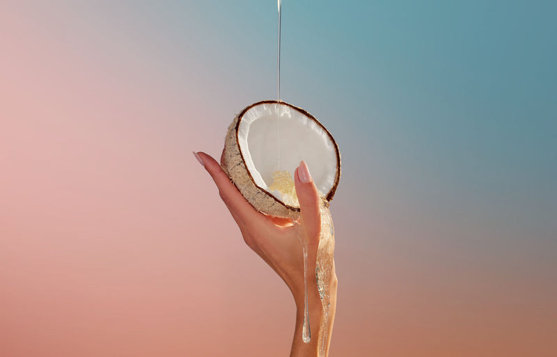 Coconut wax poured into a fresh coconut, illustrating the clean-burning coconut wax blend behind Voluspa candle safety and ingredients